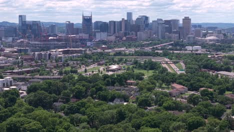 urban cityscape of nashville with expansive greenery and infrastructure from a high perspective. aerial rising shot