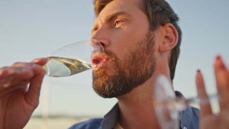 partying hipster drinking champagne enjoying friends weekend gathering close up.