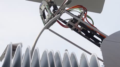 Close-up-of-pantograph-going-down-on-roof-of-electric-bus---slow-motion