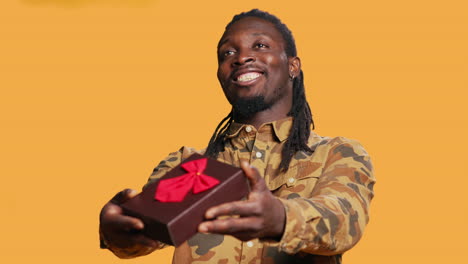 sweet boyfriend giving present box with ribbon and bow