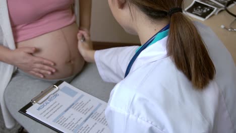 pregnant woman and gynecologist doctor at hospital