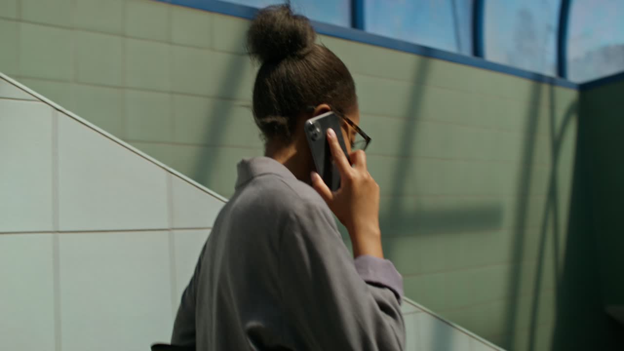 Woman on Stairs Talking on Phone