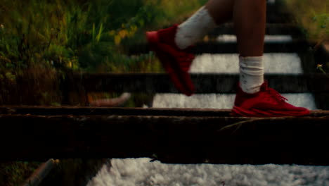 person walking across a canal bridge