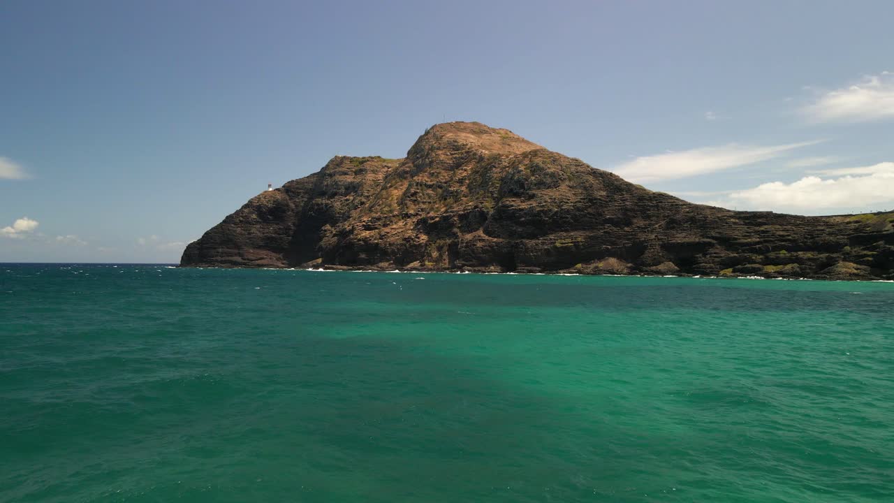 Beautiful low angle shot of a drone heading towards Makapuu lighthouse