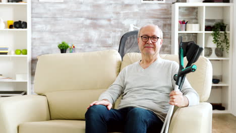 portrait of elderly retired man smiling to the camera in cozy nursing home