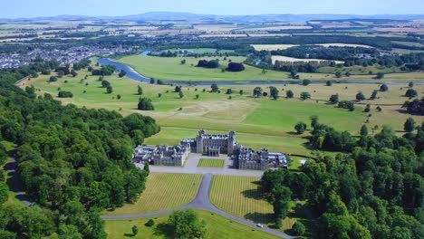 aerial of floors castle in scottish countryside