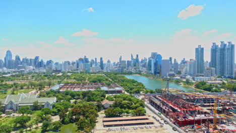 Queen-Sirikit-National-Convention-Centre-construction-site-near-Benjakitti-Park-and-Lake,-Millenium-Residence-Apartment,-CTI-Tower,-Ocean-Tower-in-Bangkok,-Thailand-on-Sunny-day-time-lapse