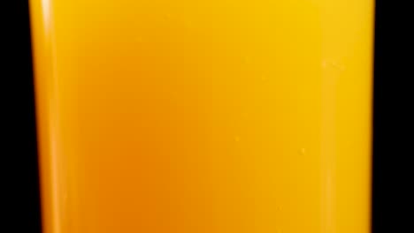 orange juice being poured into a glass