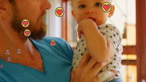 animation of heart icons over caucasian father with baby