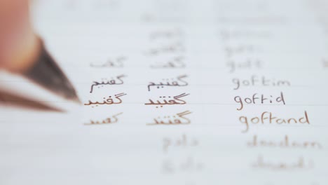 writing out persian  verbs in notebook studying