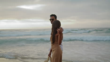 affectionate sweethearts embracing sea landscapes. tourists talking walking