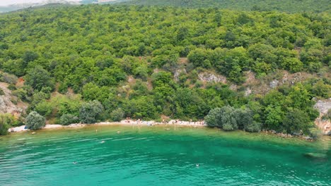 aerial truck shot from left to right of macedonian shore in ohrid lake, pesztani and trpejca