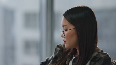 Yawning-girl-stretching-hands-workplace-closeup.-Tired-designer-looking-window