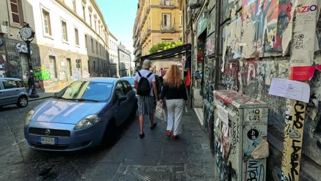 couple explores graffiti-covered street and market stalls