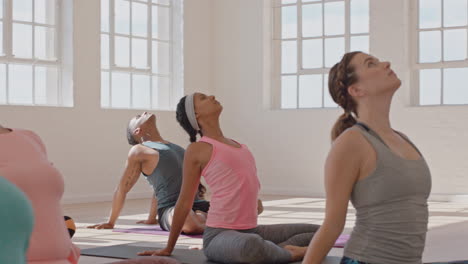 yoga-class-group-of-young-multiracial-people-practicing-poses-stretching-body-enjoying-healthy-lifestyle-exercising-in-fitness-studio