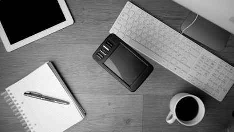 Smartphone-falling-onto-office-desk-in-black-and-white