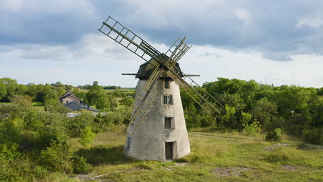 aerial shot of an old windmill made of stone and wood