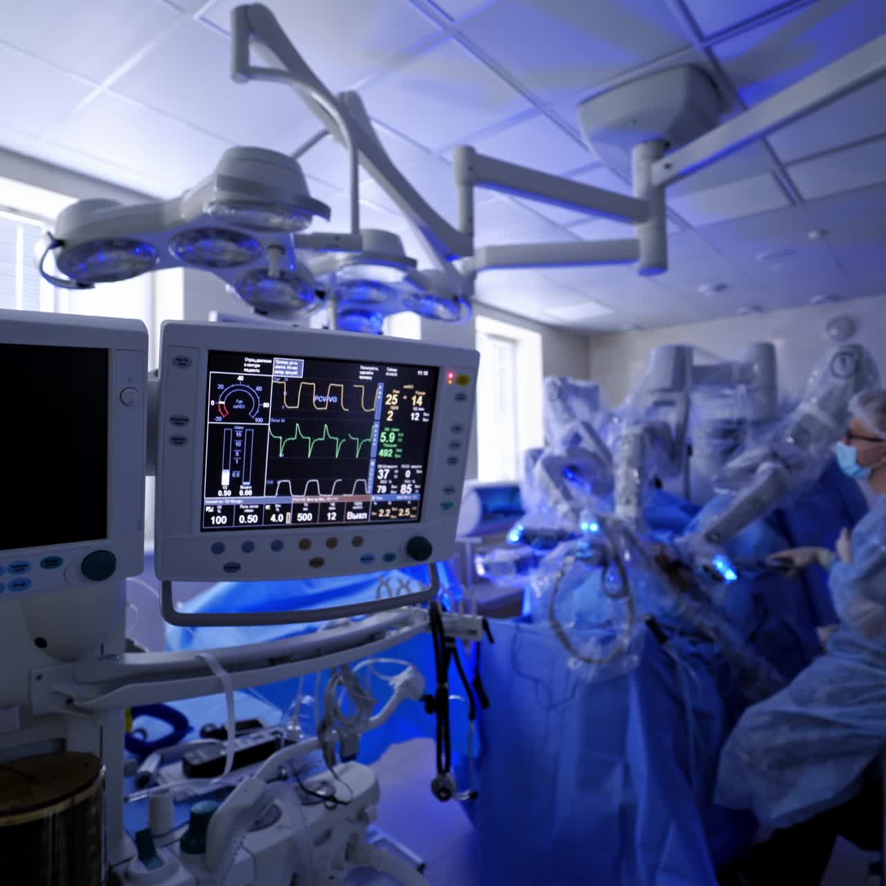 Modern medical equipment during robotic surgery. Medical monitor shows vital signs of a patient. Da vinci surgical system in hospital theater.
