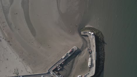 drone shot of dry port and beach in balbriggan sea town in ireland - aerial