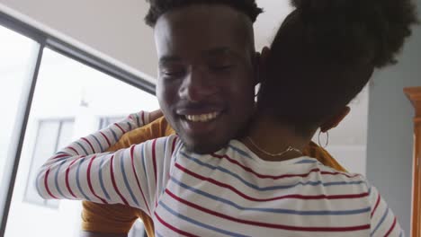 Video-of-happy-african-american-couple-embracing-at-home