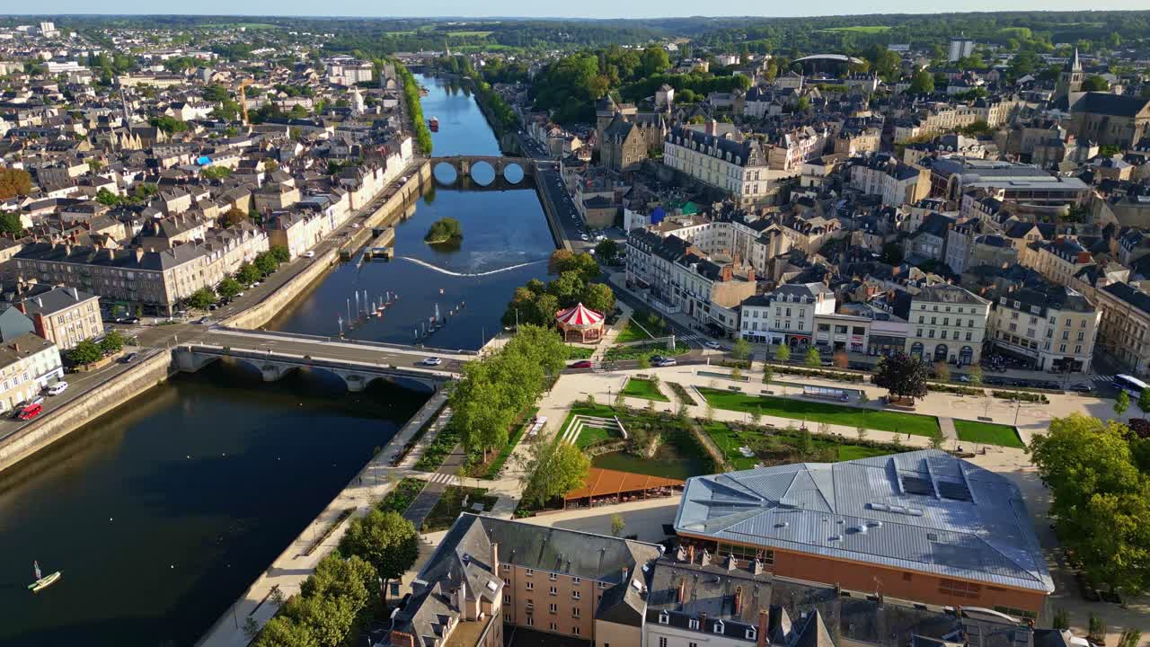 Aerial dolly over Laval showing central bridge, chateaux, and Notre Dame church in daylight