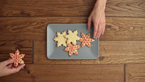 Close-up-of-people-eating-Christmas-cookies