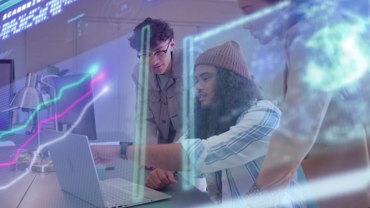 Seated dev typing on laptop and activating holograms while team pointing at charts for tech review