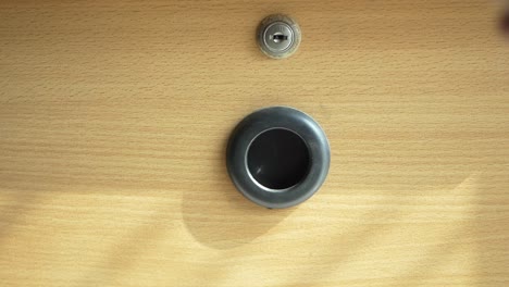 hand pressing button on a wooden desk