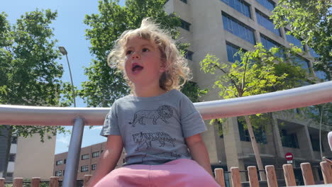 small girl spinning on roundabout