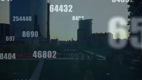 animation of multiple changing numbers and symbols against aerial view of cityscape