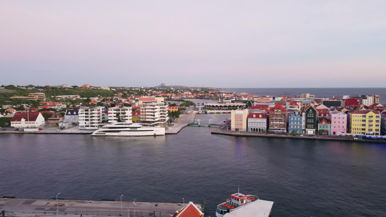 Willemstad Curaçao Aerial Establishing Pan of Colorful Punda Buildings on Handelskade Street across St. Anna Bay in 4K