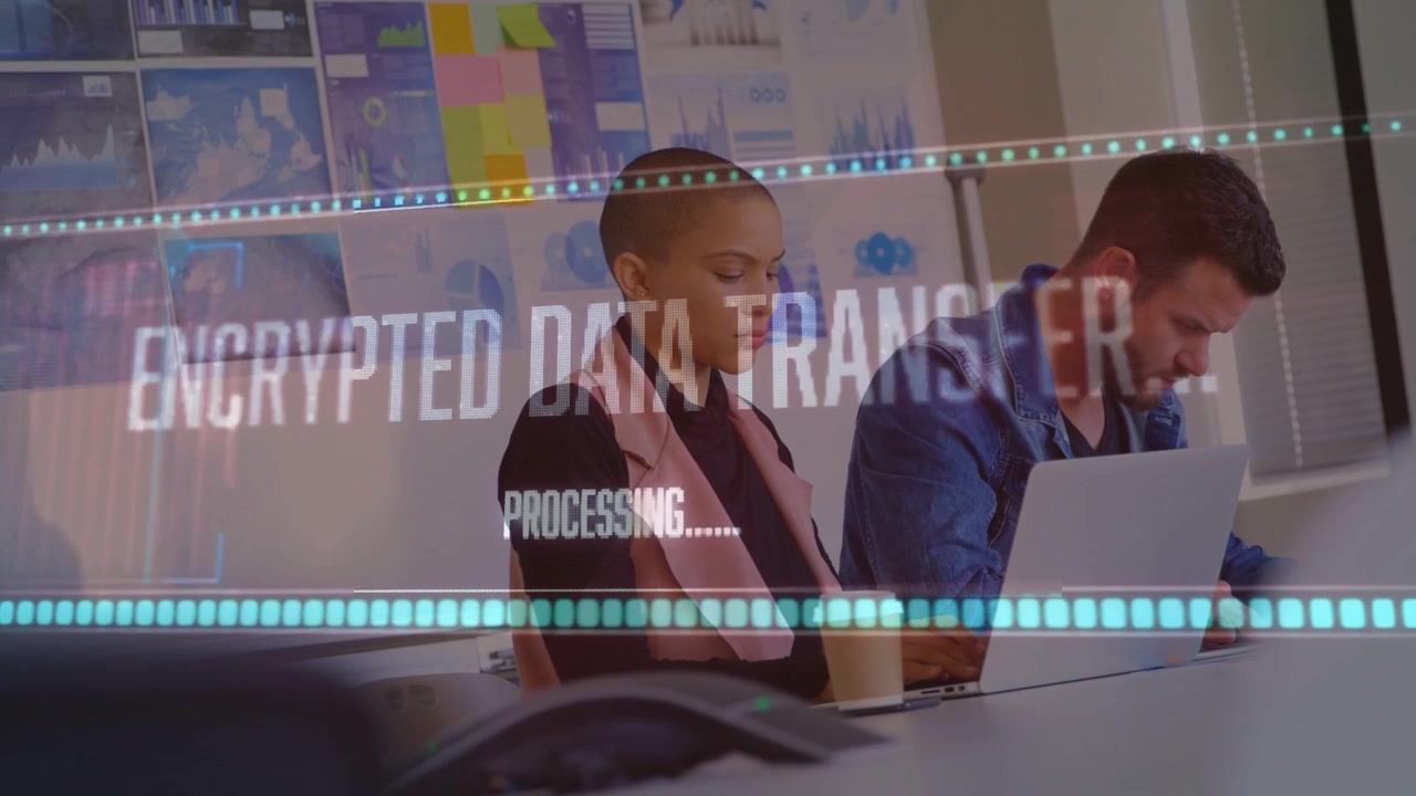 Woman glancing at device, man typing laptop, overlay appearing processing encrypted data for tech
