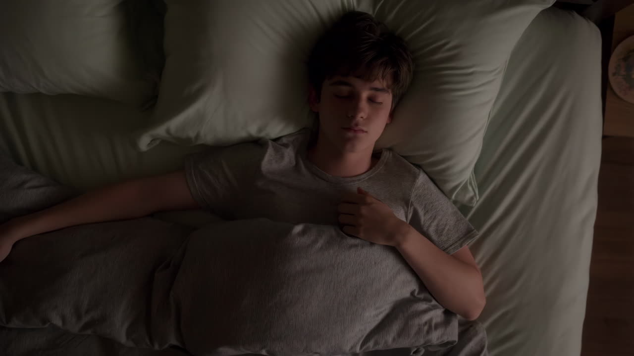 A young person sleeping peacefully in bed