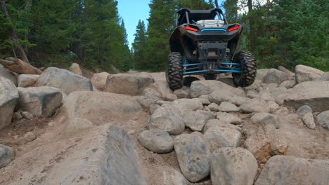 rzr going over rocks on the trail