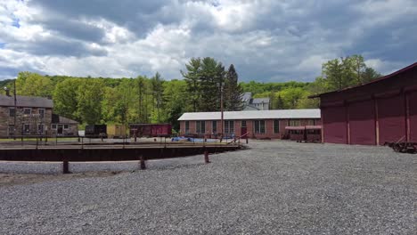 view of an abandoned narrow gauge coal rail road round house and turntable and support building starting to be restored