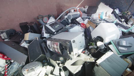 heap of various kinds of discarded electronics at disposal center, slider shot