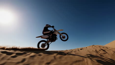 dirt biker riding through desert sand dunes