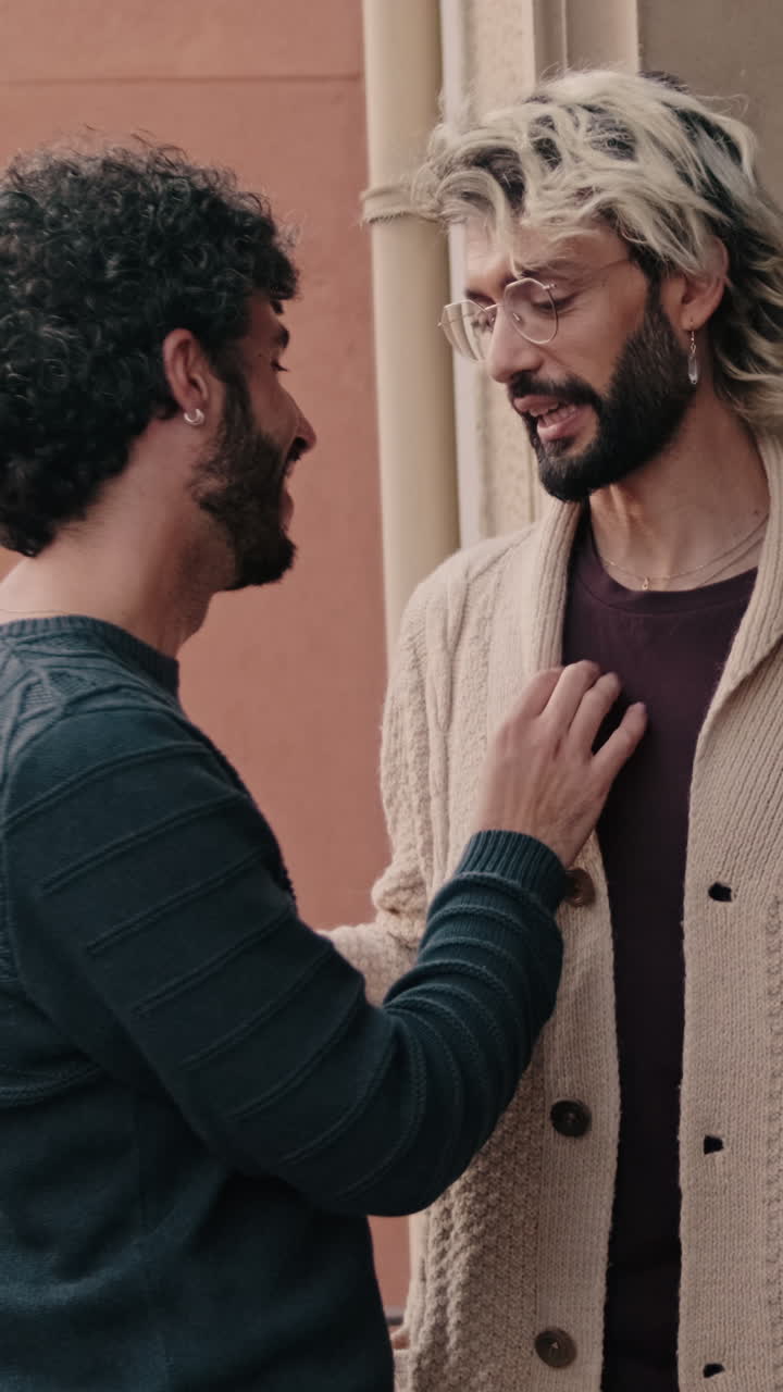 Gay Couple Embracing on Apartment Balcony