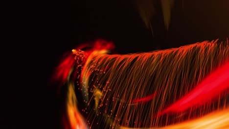 animation of glowing orange light trails moving on back background