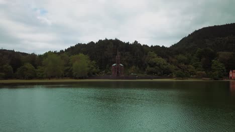 Aerial-drone-video-of-a-catholic-church-in-a-natural-landscape-close-to-a-lake-in-Azores-volcanic-islands