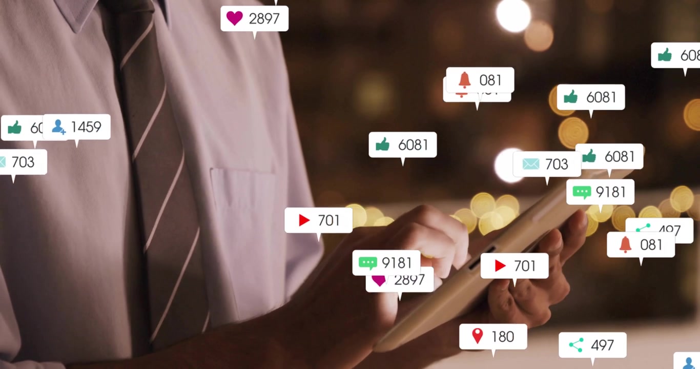 Business professional tapping tablet with notification icons floating over warm blurred lights
