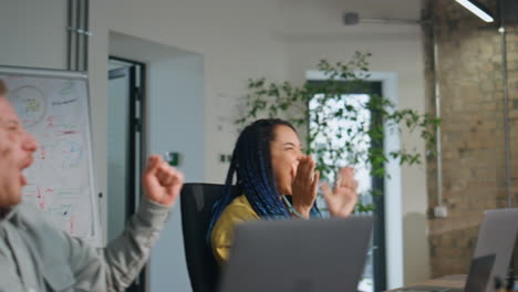 overjoyed boss celebrating achievement team with office colleagues close up.