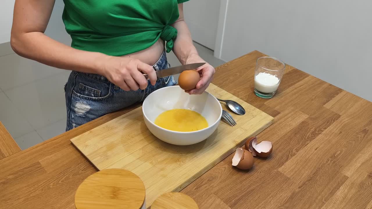 Mixing eggs in a bowl for cooking