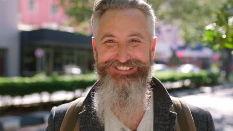 smiling senior man laughing on a city street