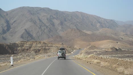 Slow-mo-shot-following-a-car-as-it-drives-along-the-country-road-through-Ethiopia