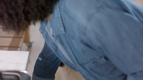 midsection of biracial woman serving dog food at home, slow motion