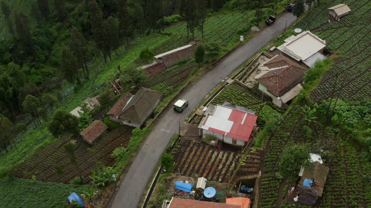 Cemoro Lawang Aerial tracking shot as truck drives through mountain village