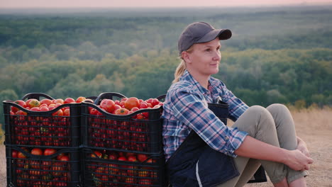 woman farmer resting after harvesting tomato