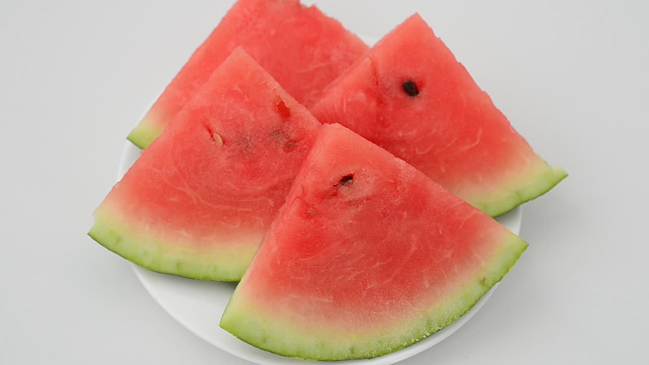 Shooting of a watermelon on a white background. Shooting in the movement