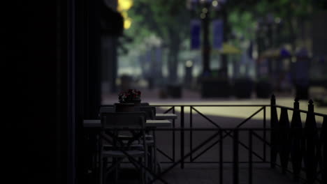 quiet outdoor cafe seating in a bustling city during early evening hours